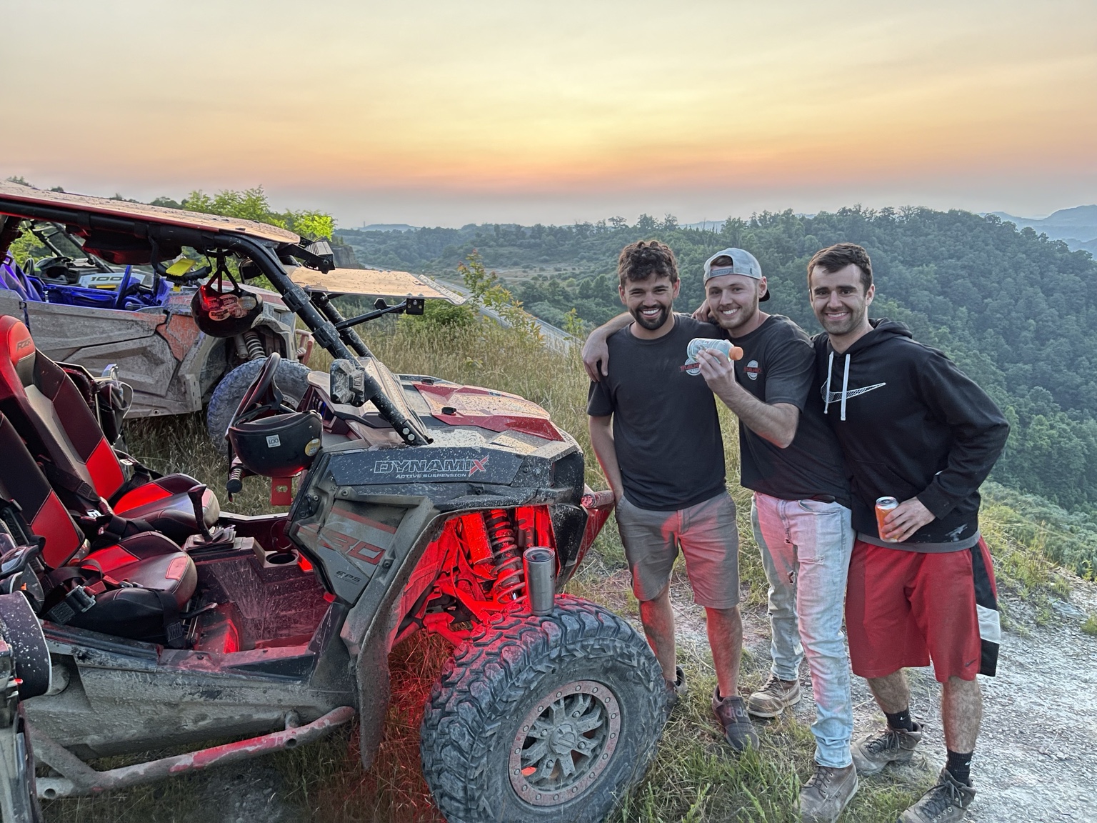 Riders at a mountain overlook at sunset