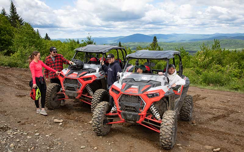 Polaris RZR side-by-side rental machines on an off-road trail near the Hatfield-McCoy Trails
