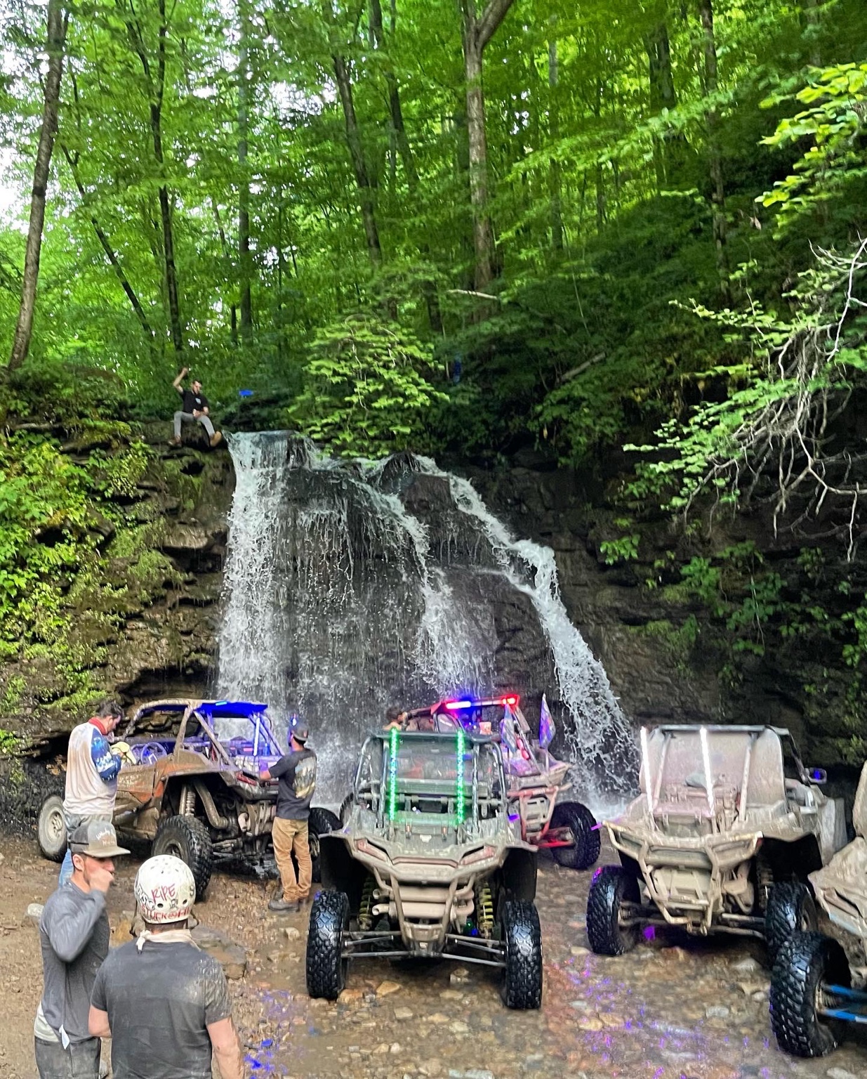 Side-by-sides stopped at a waterfall on a Hatfield-McCoy Trails ride